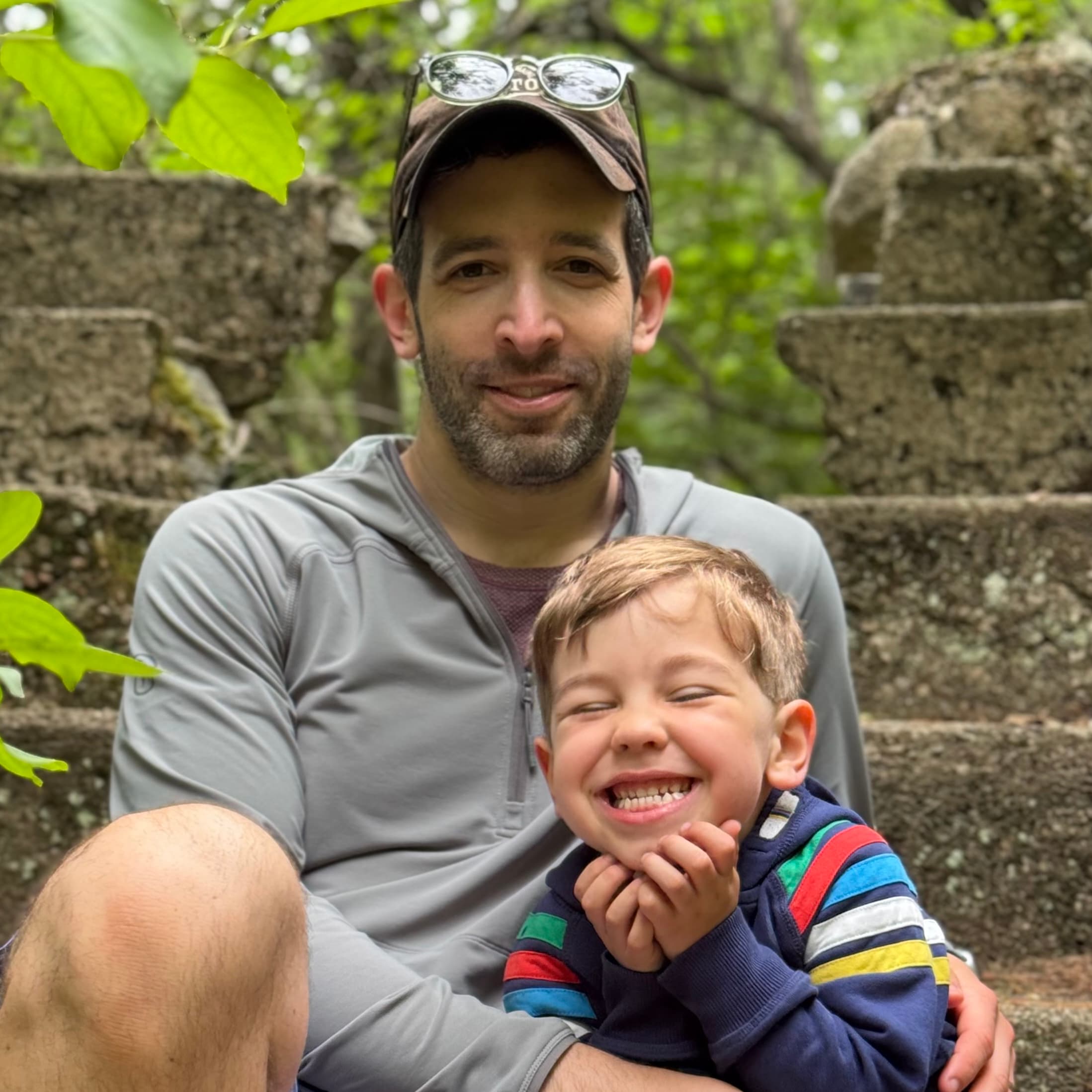 father and son smiling together on a hike