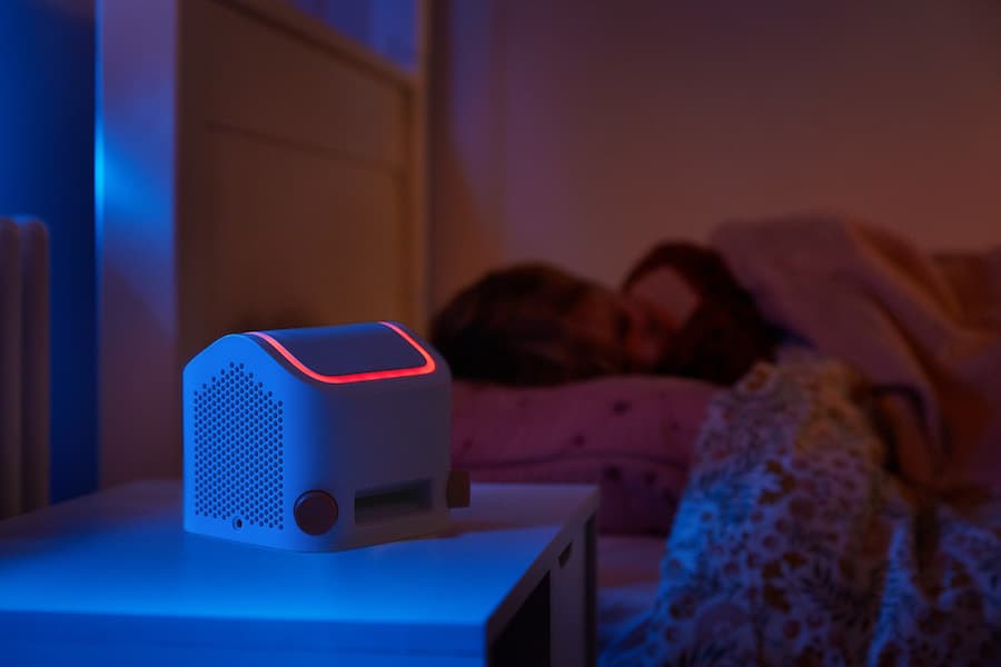 darkened child's room with a Yoto emitting a nightlight